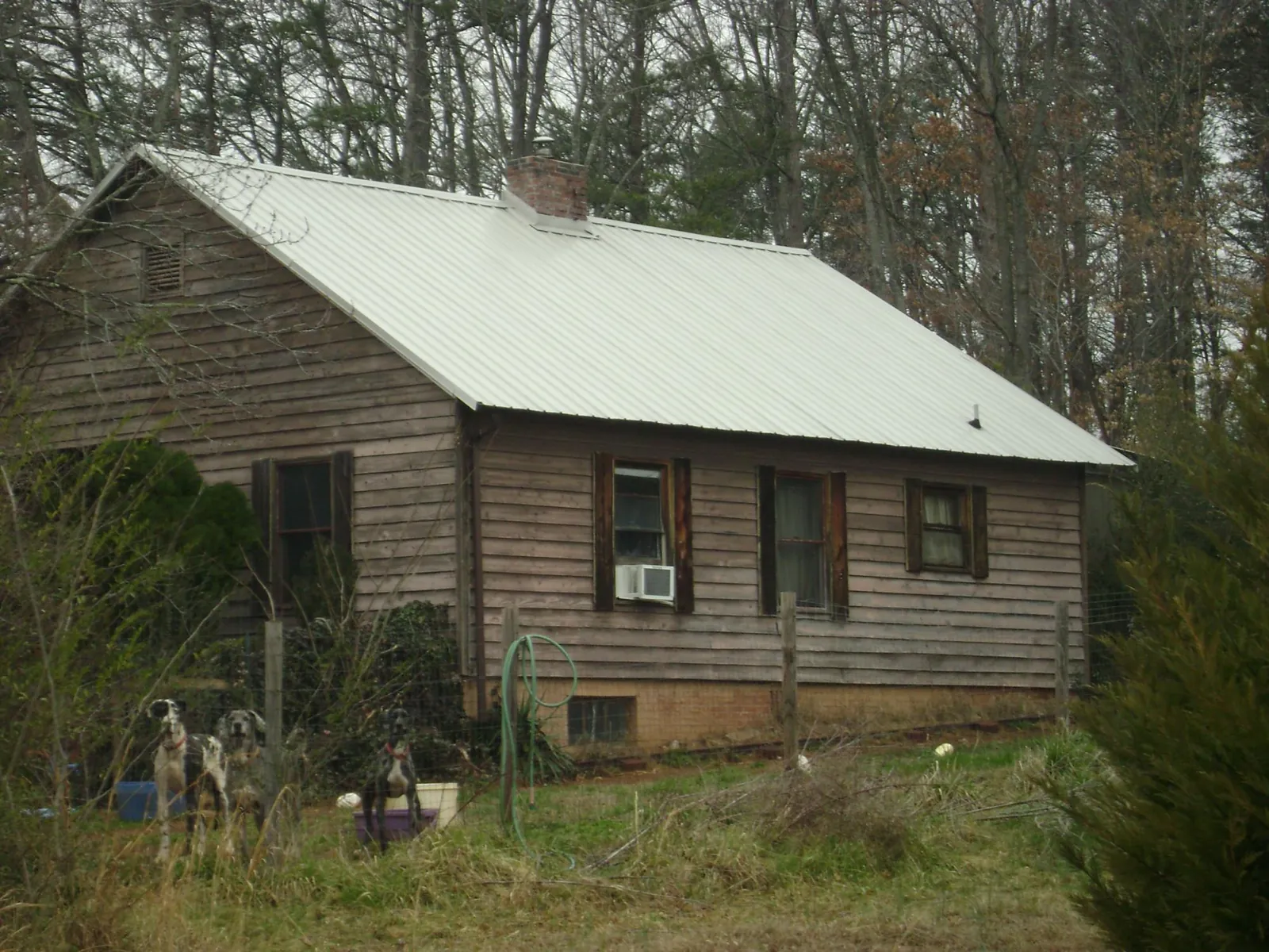 White metal roof on an old wood sided farmhouse in Clarksville